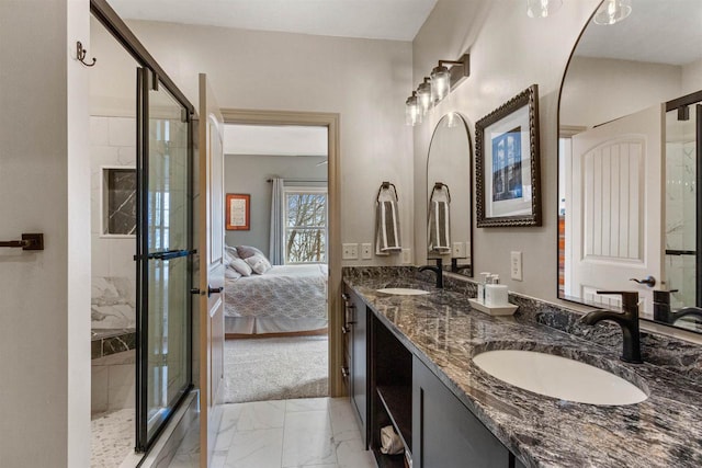 ensuite bathroom featuring ensuite bathroom, marble finish floor, a shower stall, and a sink