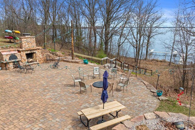 view of patio featuring an outdoor stone fireplace