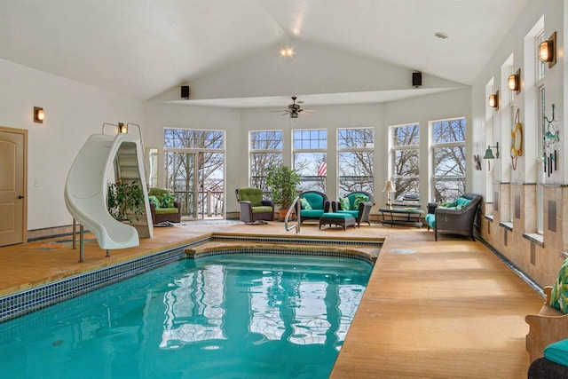 pool featuring a water slide and a ceiling fan