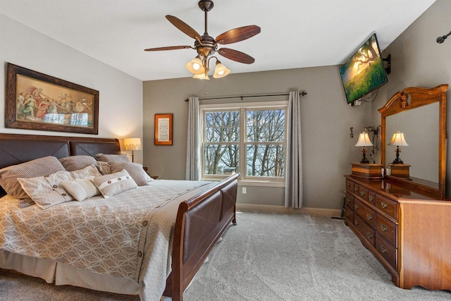 bedroom featuring baseboards, ceiling fan, and light colored carpet