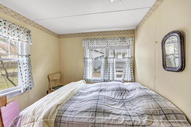 bedroom featuring multiple windows