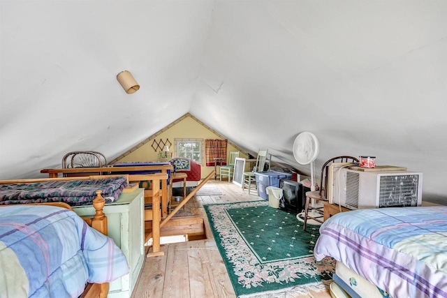 bedroom featuring lofted ceiling and hardwood / wood-style floors