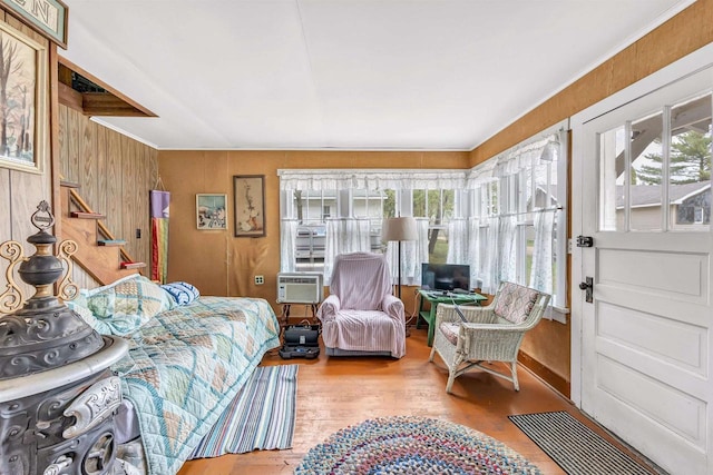 bedroom featuring wood walls and wood finished floors