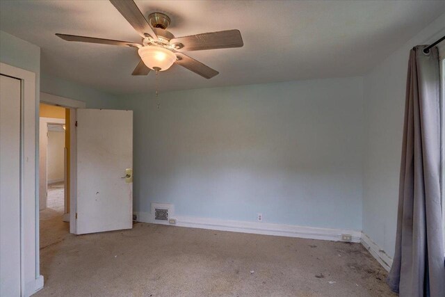 unfurnished bedroom featuring ceiling fan, carpet floors, baseboards, and visible vents