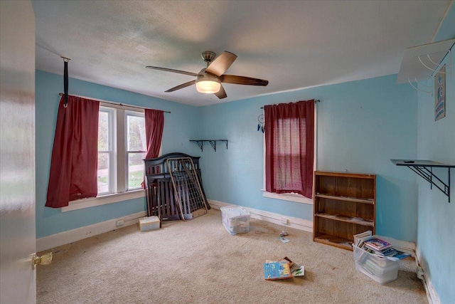 bedroom featuring baseboards, ceiling fan, and carpet floors