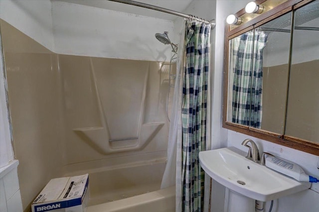 bathroom featuring a sink and shower / bathtub combination with curtain