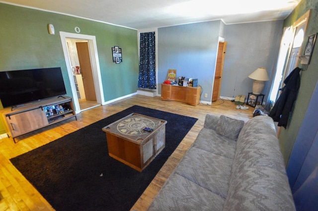 living area featuring baseboards and wood finished floors