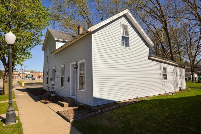 view of property exterior with a yard