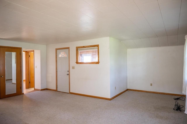 interior space featuring carpet and baseboards