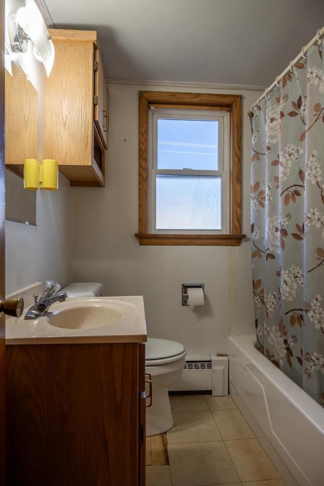 bathroom featuring a baseboard radiator, toilet, tile patterned flooring, vanity, and shower / bath combo