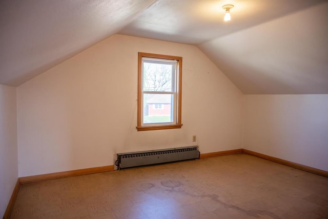 bonus room with a baseboard radiator, lofted ceiling, and baseboards