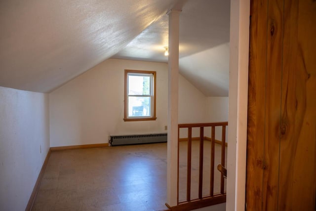 additional living space with baseboards, a baseboard radiator, tile patterned floors, and lofted ceiling