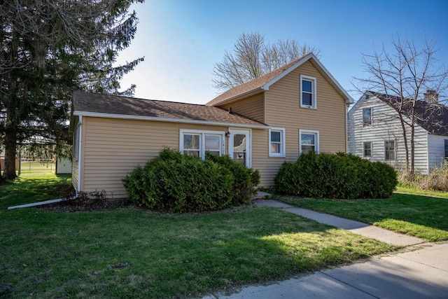 traditional-style home featuring a front lawn