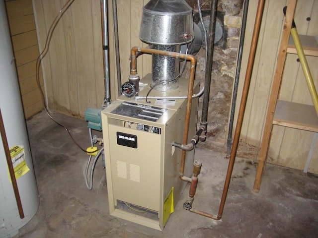 utility room with water heater and a heating unit