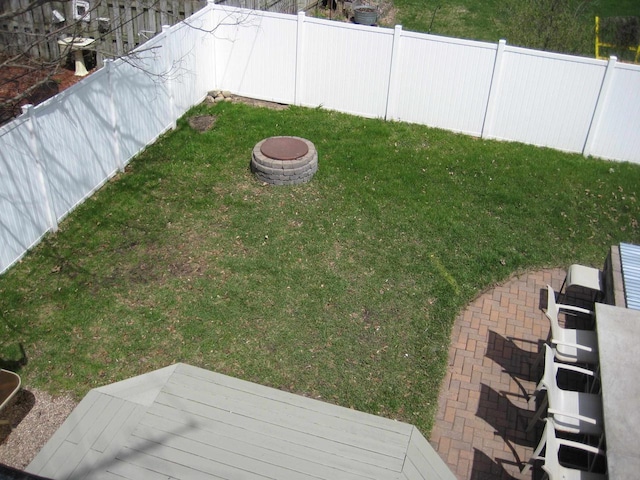 view of yard featuring an outdoor fire pit and fence