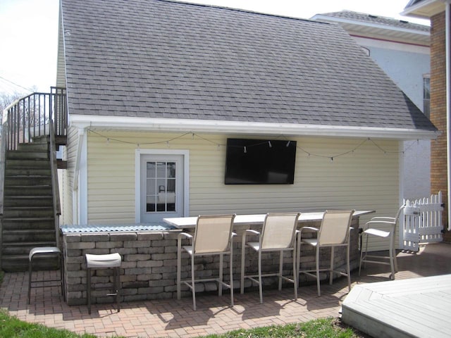 exterior space with outdoor dry bar and stairs