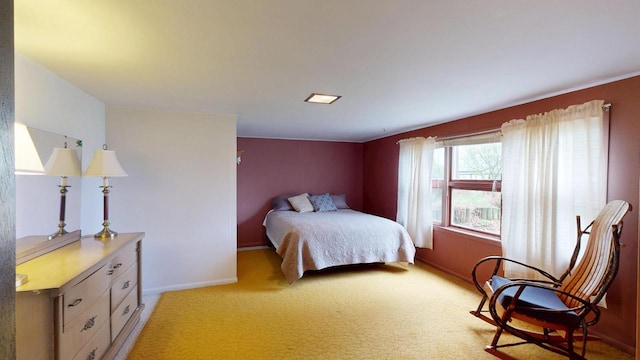 bedroom with baseboards and light colored carpet