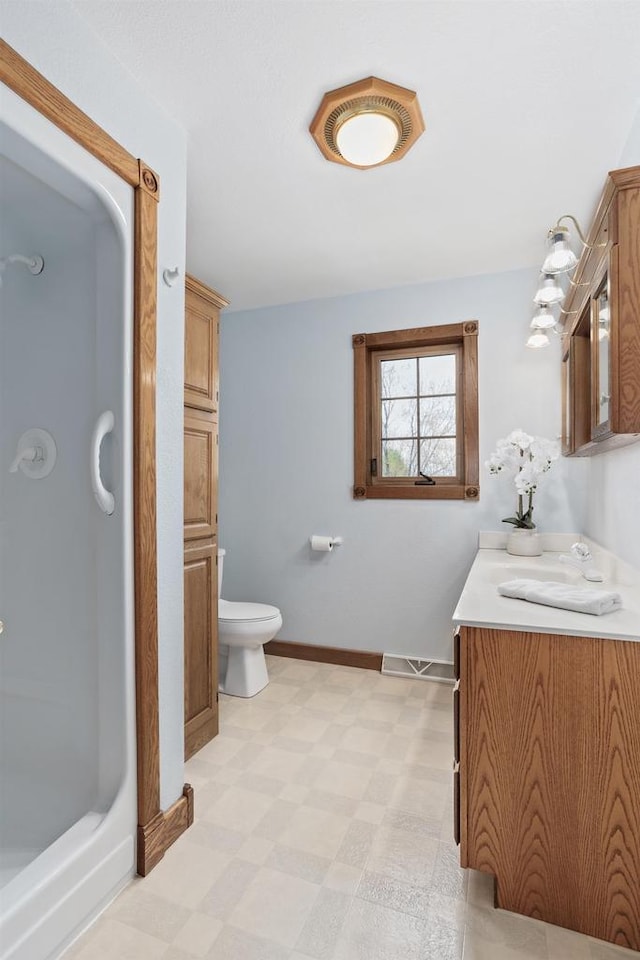 W11330 Rose Eld Rd, Ripon, WI 54971 - full bath with toilet, vanity, tile patterned floors, a stall shower, and baseboards