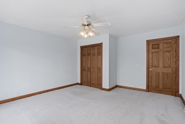 W11330 Rose Eld Rd, Ripon, WI 54971 - unfurnished bedroom featuring a closet, light carpet, baseboards, and a ceiling fan