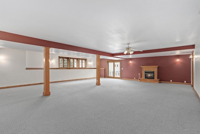 W11330 Rose Eld Rd, Ripon, WI 54971 - unfurnished living room featuring carpet floors, baseboards, a ceiling fan, and a glass covered fireplace