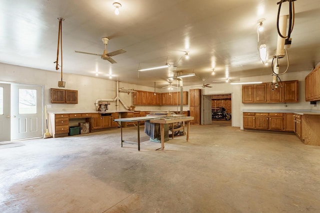 W11330 Rose Eld Rd, Ripon, WI 54971 - recreation room with ceiling fan, a workshop area, and unfinished concrete flooring