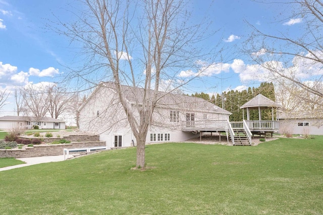 W11330 Rose Eld Rd, Ripon, WI 54971 - rear view of property featuring a lawn, a gazebo, stairway, and a wooden deck
