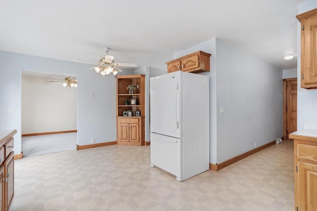 W11330 Rose Eld Rd, Ripon, WI 54971 - kitchen with freestanding refrigerator, light floors, baseboards, ceiling fan, and light countertops