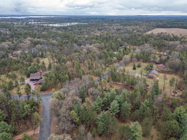 birds eye view of property with a view of trees