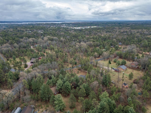 aerial view featuring a wooded view
