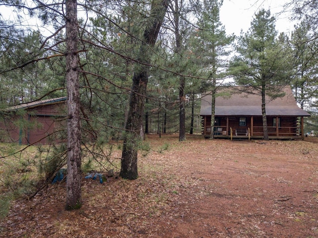 view of yard with covered porch