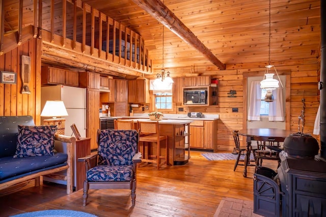 living room featuring wooden ceiling, wooden walls, light wood-style flooring, and vaulted ceiling with beams