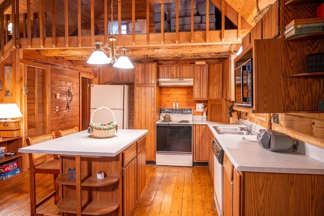 kitchen with a sink, brown cabinetry, white appliances, open shelves, and under cabinet range hood