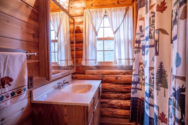 bathroom with vanity and rustic walls