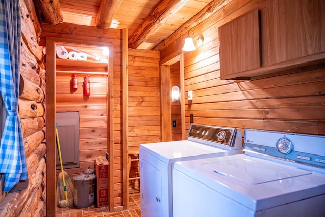 laundry room featuring brick floor, wooden ceiling, wooden walls, washing machine and clothes dryer, and laundry area