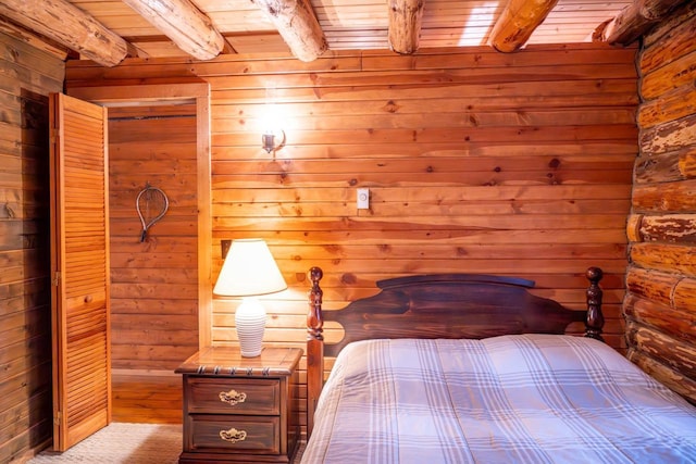 bedroom with beam ceiling and wooden ceiling
