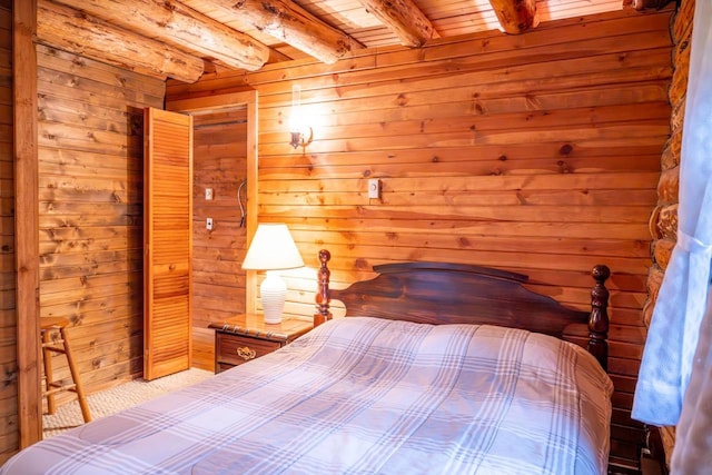 bedroom with wooden ceiling, wood walls, and beam ceiling