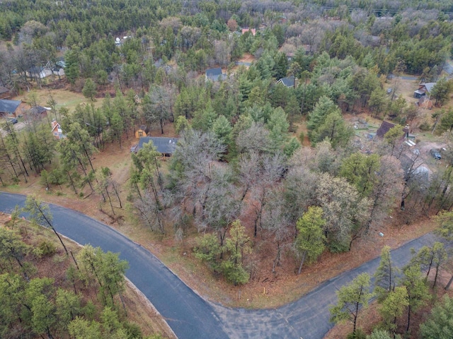 birds eye view of property with a forest view