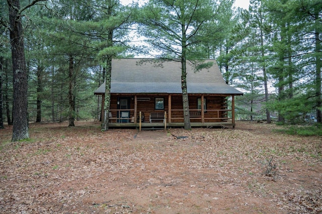 rear view of property featuring a porch and log exterior