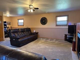 carpeted living room featuring ceiling fan