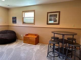 living area with baseboards and carpet flooring
