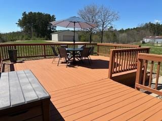 wooden terrace featuring outdoor dining space