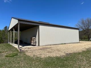 view of side of home featuring an outbuilding and a carport