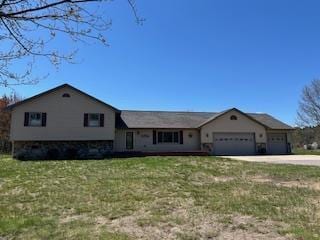 split level home with an attached garage, driveway, and a front yard