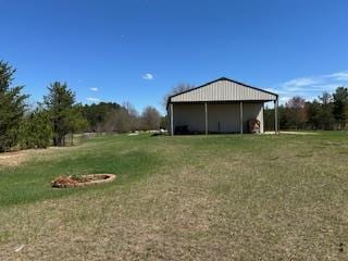 view of yard featuring an outdoor structure and an outbuilding