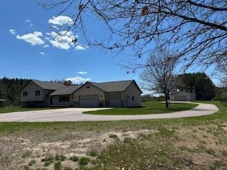 exterior space with a front lawn, driveway, and an attached garage