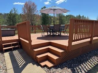 wooden terrace featuring outdoor dining space