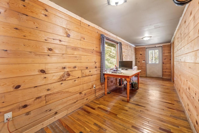 office space with wood walls and wood-type flooring