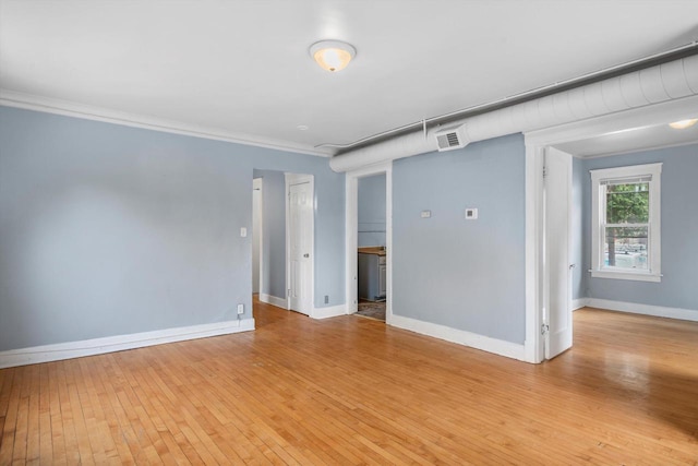 3303 W Juneau Ave Unit 3311, Milwaukee, WI 53208 - unfurnished room featuring ornamental molding, baseboards, light wood-type flooring, and visible vents