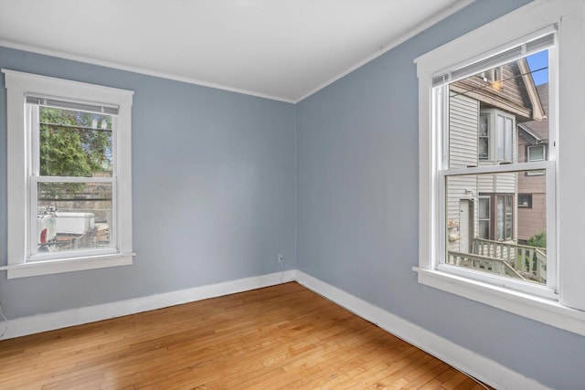 3303 W Juneau Ave Unit 3311, Milwaukee, WI 53208 - unfurnished room featuring ornamental molding, wood-type flooring, and baseboards