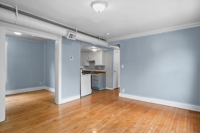 3303 W Juneau Ave Unit 3311, Milwaukee, WI 53208 - unfurnished living room featuring light wood finished floors, crown molding, and baseboards